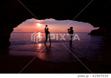 Silhouette of woman standing using camera to take Silhouette of woman standing using camera to take 62907030