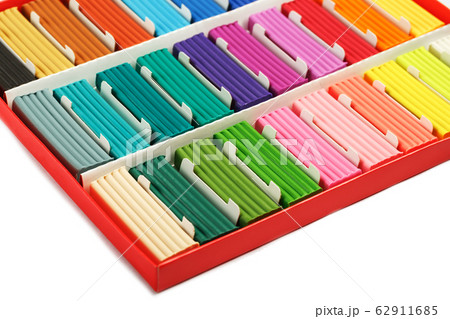 Multicolored plasticine in a box on a white Multicolored plasticine in a box on a white 62911685