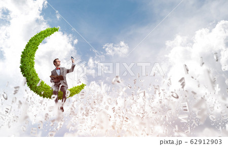 Young businessman or student studying the science and symbols fly around Young businessman or student studying the science and symbols fly around 62912903