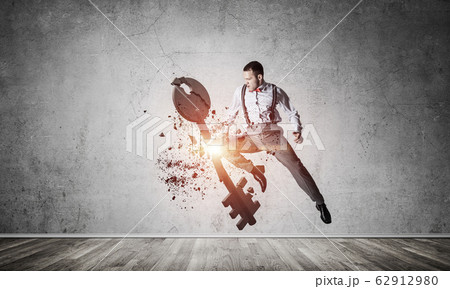 Breaking through access concept with furious man in room crashin 62912980