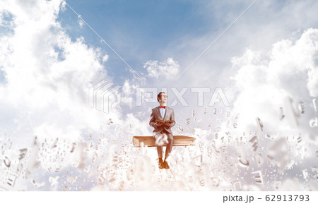 Young businessman or student studying the science and symbols fly around Young businessman or student studying the science and symbols fly around 62913793