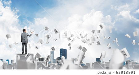 Businessman standing with megaphone. 62913891