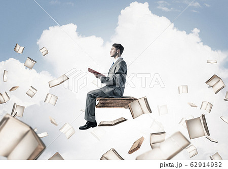 Man reading book and many of them flying in air Man reading book and many of them flying in air 62914932