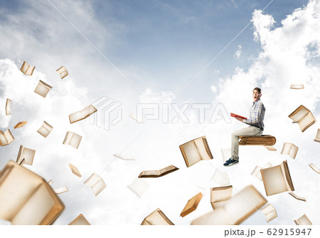 Man reading book and many of them flying in air Man reading book and many of them flying in air 62915947