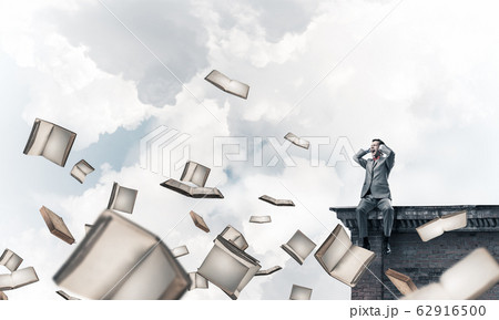 Young man sitting on top and dont want to hear anything Young man sitting on top and dont want to hear anything 62916500