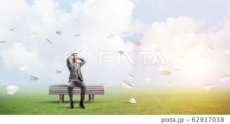 Young man in suit in park dont want to hear anything 62917038
