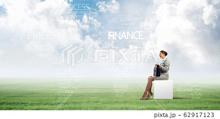 Attractive business lady or accountant outdoors on white box Attractive business lady or accountant outdoors on white box 62917123