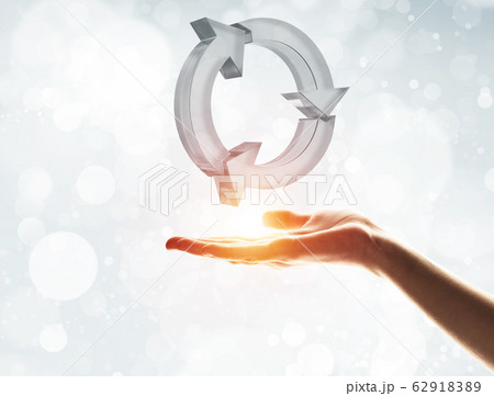 Concept of reuse and recycle presented by glass icon in palm 62918389