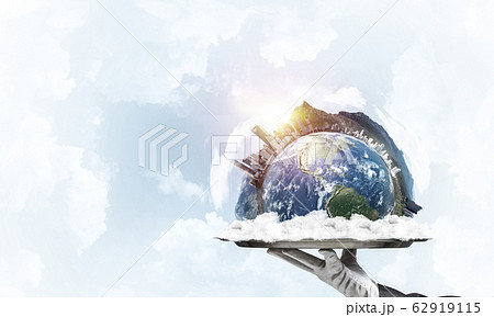 Hand of waitress presenting Earth globe on tray. Hand of waitress presenting Earth globe on tray. 62919115