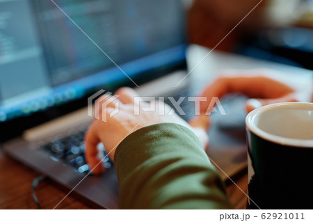 closeup mans hands freelancer sitting in cafe working laptop 62921011