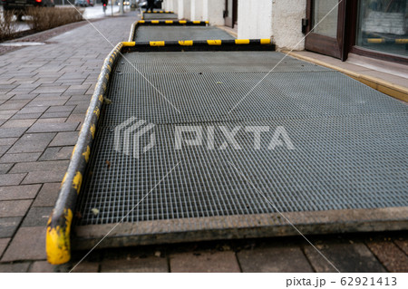 WHEELCHAIR RAMP with grid, yellow warning lines on sides WHEELCHAIR RAMP with grid, yellow warning lines on sides 62921413