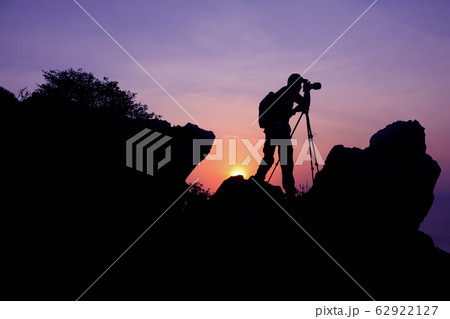 Photographer climbing on the top of the mountain Photographer climbing on the top of the mountain 62922127