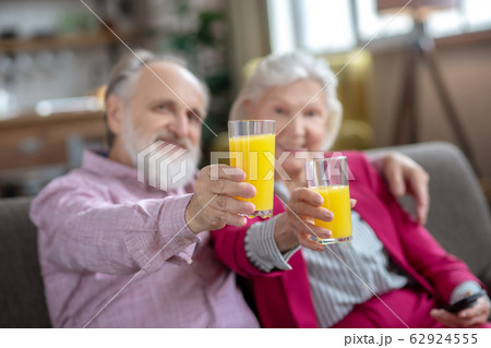 Married senior couple having orange juice and feeling great 62924555