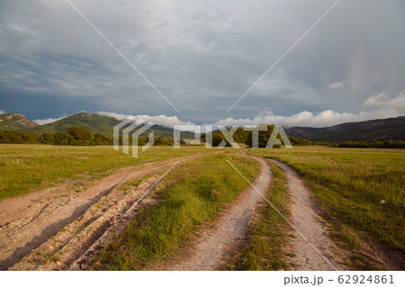 Country road disappearing into the mountains 62924861