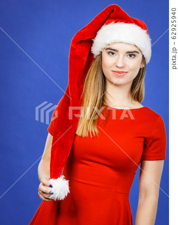 Happy woman wearing Santa Claus helper costume 62925940