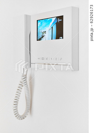 On white wall video intercom with street view 62926173