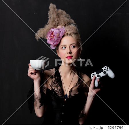 Beautiful blonde countess with a joystick and cup Beautiful blonde countess with a joystick and cup 62927964