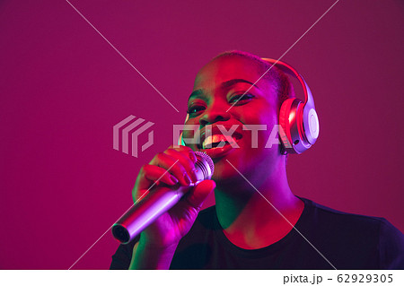 African-american young woman's portrait on purple pink background African-american young woman's portrait on purple pink background 62929305