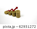 Growing stack of coins with rising red arrow. 62931272