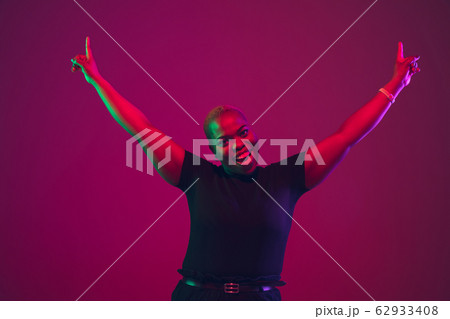 African-american young woman's portrait on purple pink background African-american young woman's portrait on purple pink background 62933408