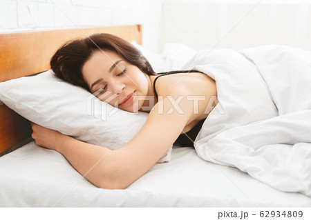 Young woman sleeping in bed, close up Young woman sleeping in bed, close up 62934809