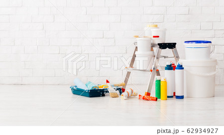 Painting walls in new apartment with ladder and instruments 62934927