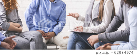 Mentor discussing problem with therapy group members at meeting in rehab Mentor discussing problem with therapy group members at meeting in rehab 62934974