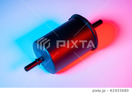 New fuel filter in a black plastic housing for diesel and gasoline engines in double red-blue light 62935680