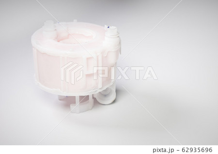 New spare part. Replaceable white plastic inner fuel filter on a gray gradient background 62935696