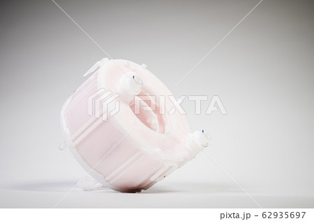 New spare part. Replaceable white plastic inner fuel filter on a gray gradient background 62935697