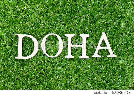 Wood letter in word doha on green grass background Wood letter in word doha on green grass background 62936233