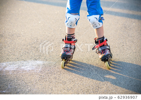 Little boy learning to roller skate in summer 62936907