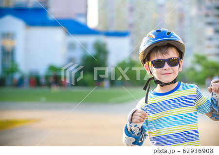 Little boy riding on rollers in the summer in the 62936908