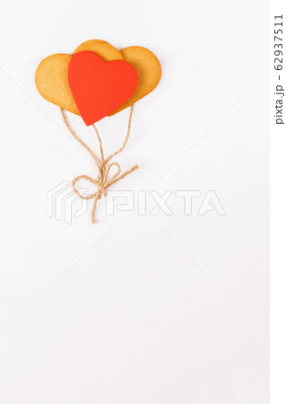 Balloons from heart shaped cookies on a white backround. Simbol of cozy love and Valentines Day backrgound and festive and birthday concept, greeting card 62937511