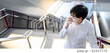 Asian man wearing mask at skytrain station 62937770