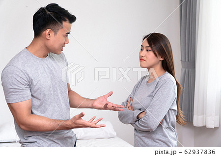 Unhappy Asian Couples standing beside each other Unhappy Asian Couples standing beside each other 62937836