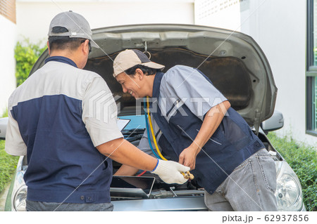 two Auto repairman checks the engine and cooling 62937856