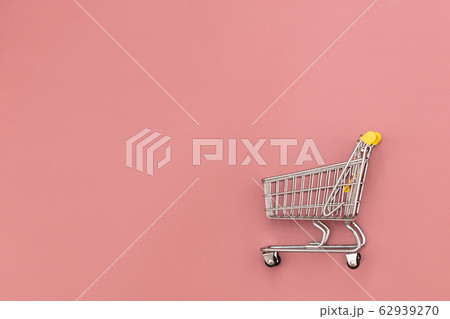 Metal shopping cart on pink background. Metal shopping cart on pink background. 62939270