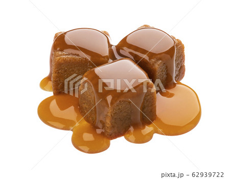 Toffee candies with caramel sauce isolated on white background 62939722