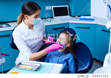 Young female dentist working in her office. Young female dentist working in her office. 62941203