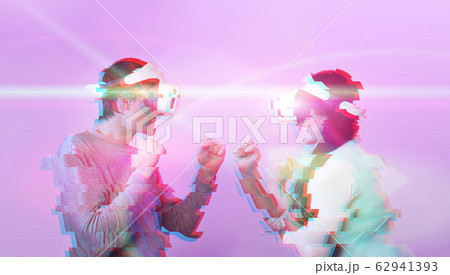 Couple with virtual reality headset are playing game and fighting. Image with glitch effect. Couple with virtual reality headset are playing game and fighting. Image with glitch effect. 62941393
