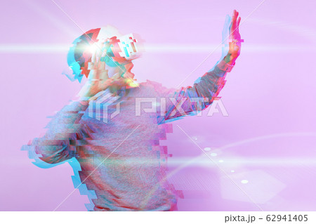Man is using virtual reality headset. Image with glitch effect. 62941405