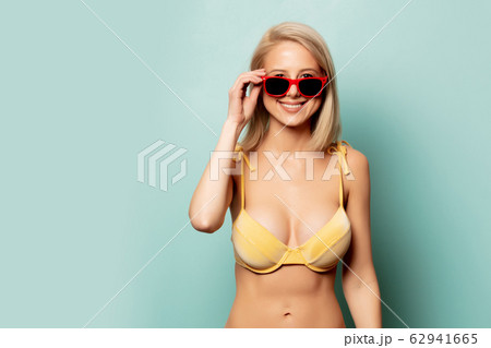 Beautiful blonde woman in yellow bikini and Beautiful blonde woman in yellow bikini and 62941665