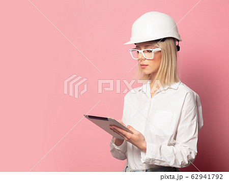 Woman in white shirt, glasses and helmet with Woman in white shirt, glasses and helmet with 62941792
