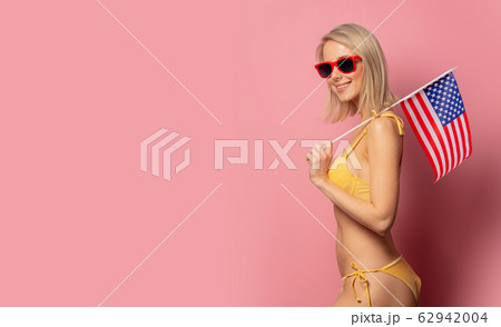 woman in yellow bikini and sunglasses with USA 62942004