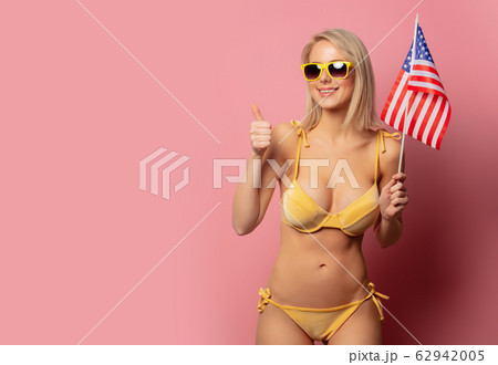 woman in yellow bikini and sunglasses with USA 62942005