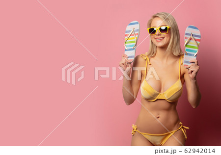 Beautiful blonde woman in yellow bikini and shoes Beautiful blonde woman in yellow bikini and shoes 62942014