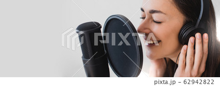 Woman blogger recording radio podcast in studio. Woman blogger recording radio podcast in studio. 62942822