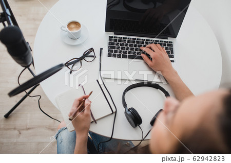 Woman blogger recording radio podcast in studio. Woman blogger recording radio podcast in studio. 62942823