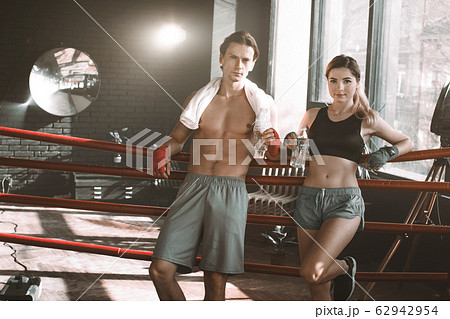 Portrait of a couple of boxers having a good time during training in a boxing gym and smiling 62942954